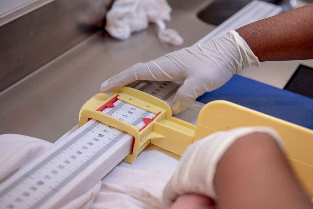 Newborn being weighed on a hospital baby scale