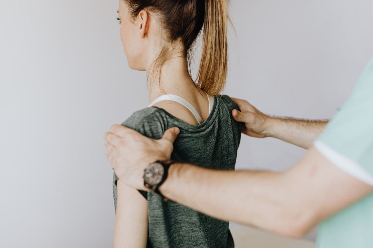 Physiotherapist guiding a patient through shoulder rehabilitation