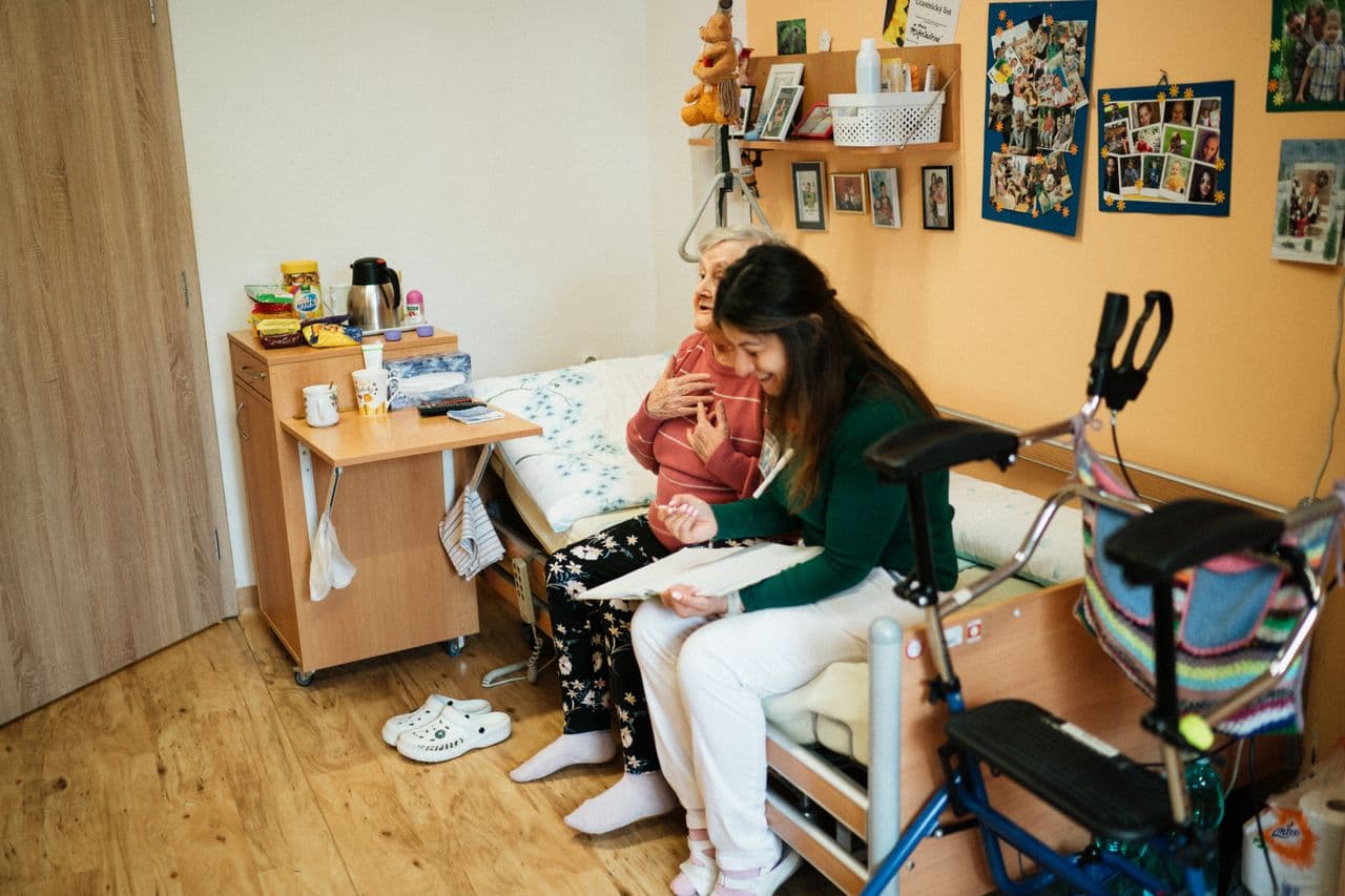 Home care nurse assisting an elderly person at home